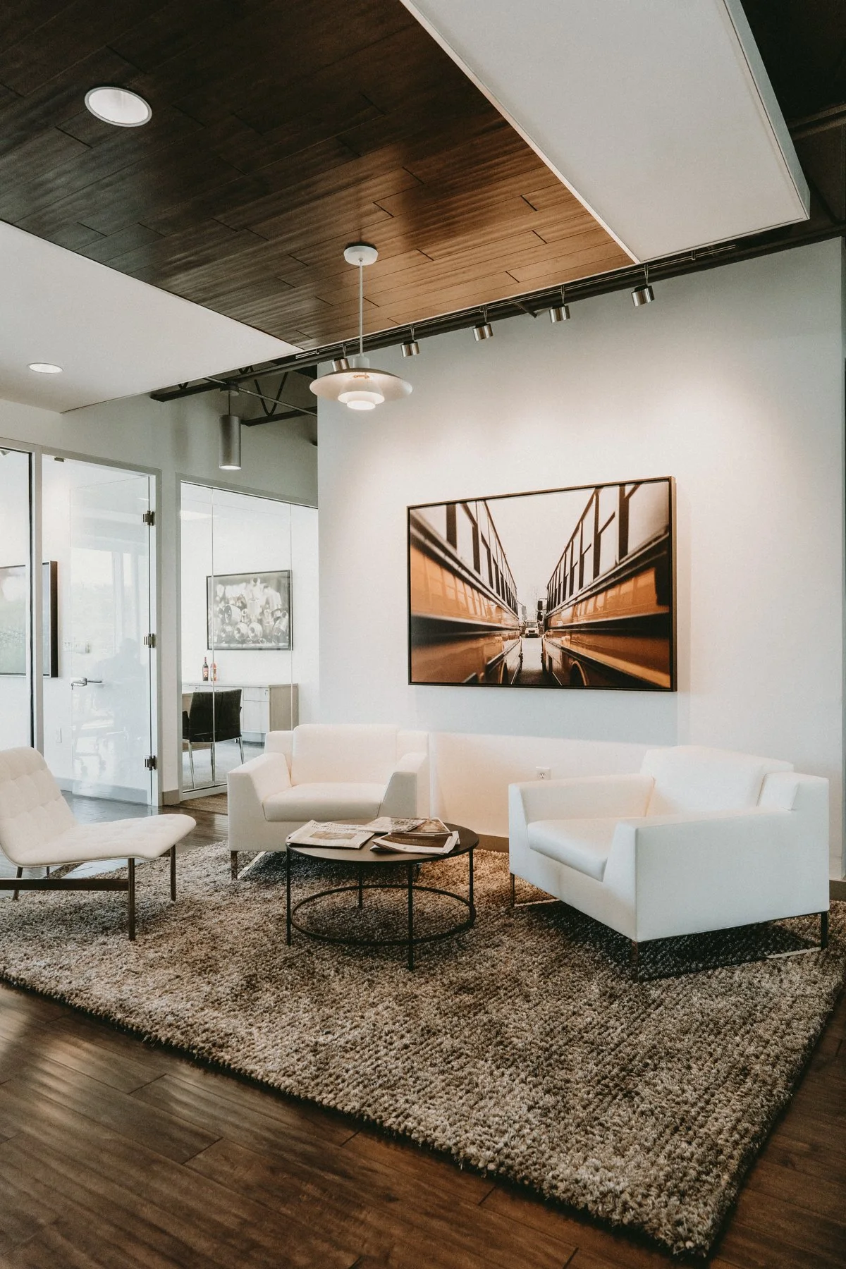 An office lounge with warm wood and sculptural artwork