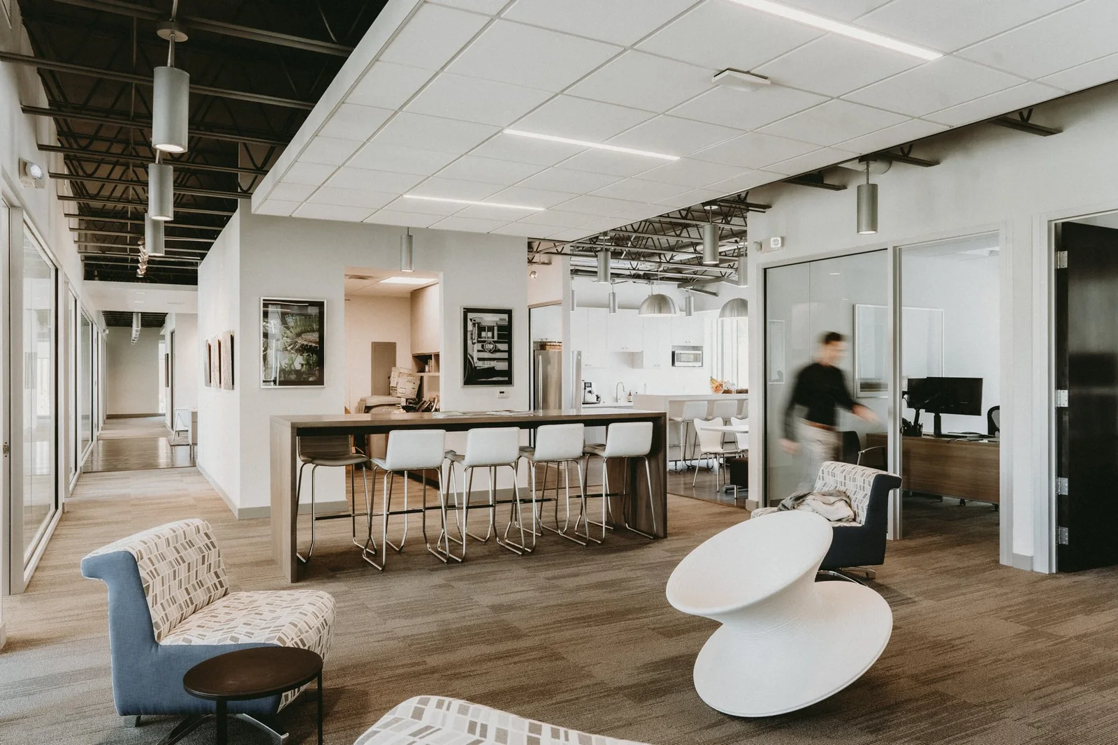 A bright office kitchen with wood and metal details